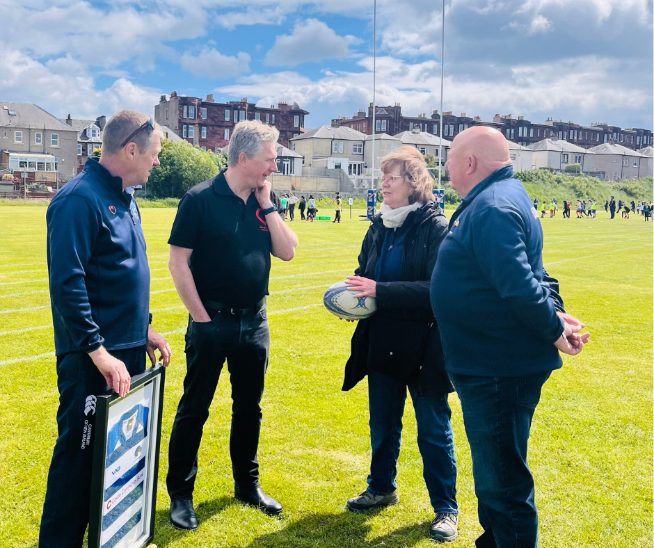 Adrian chats with team at Leith Rugby during practice at Leith Academy.