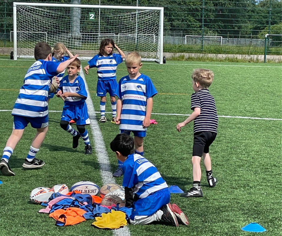 Children playing rugby in sponsored shirts at Leith Academy playing fields 